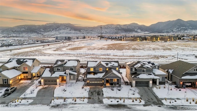 snowy aerial view with a mountain view