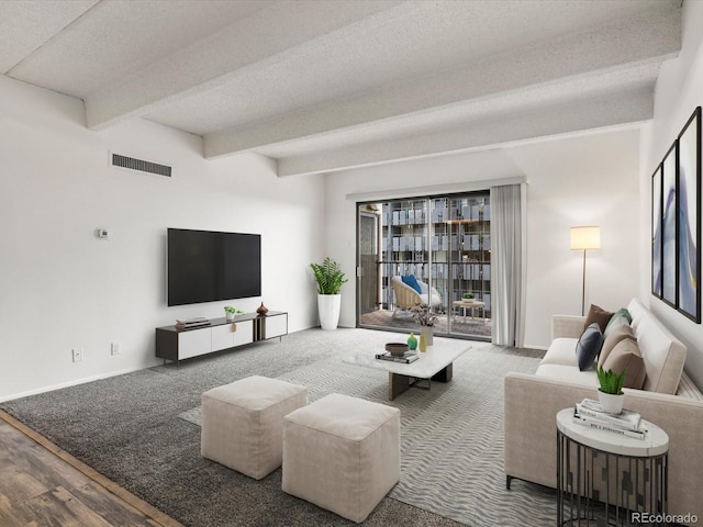 living room with beamed ceiling, wood-type flooring, and a textured ceiling