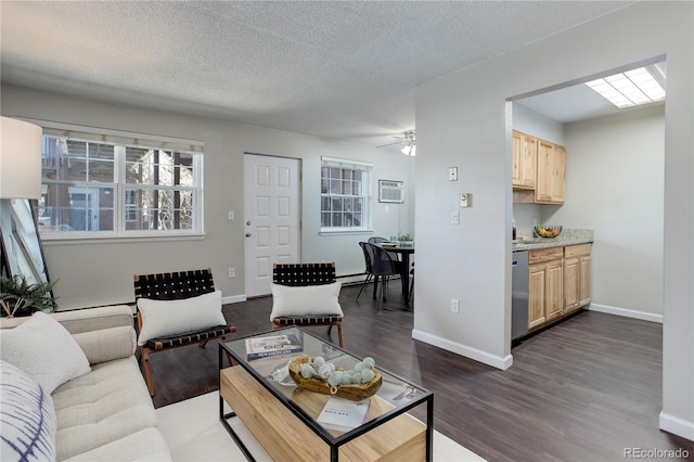 living room with dark wood-type flooring, an AC wall unit, baseboards, and a textured ceiling