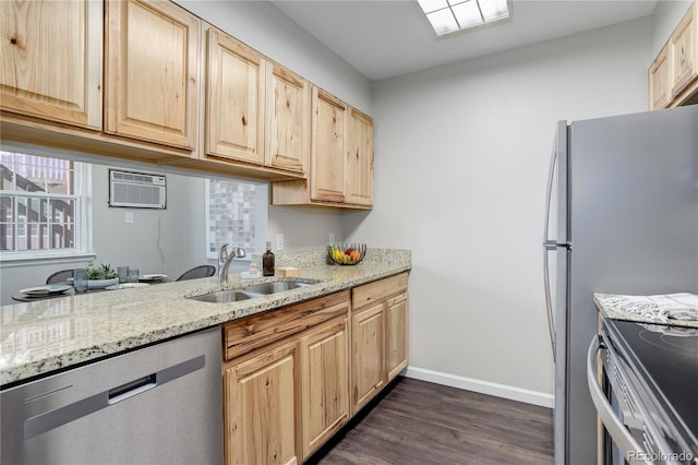 kitchen featuring light brown cabinets, appliances with stainless steel finishes, an AC wall unit, and a sink