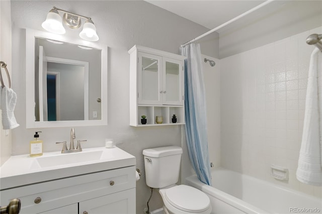 bathroom with vanity, shower / tub combo, and toilet