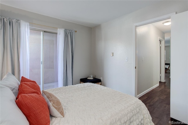 bedroom with dark wood finished floors and baseboards