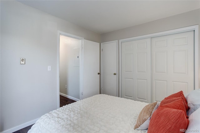 bedroom featuring a closet and baseboards