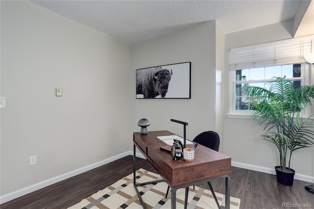 office featuring a textured ceiling, baseboards, and wood finished floors