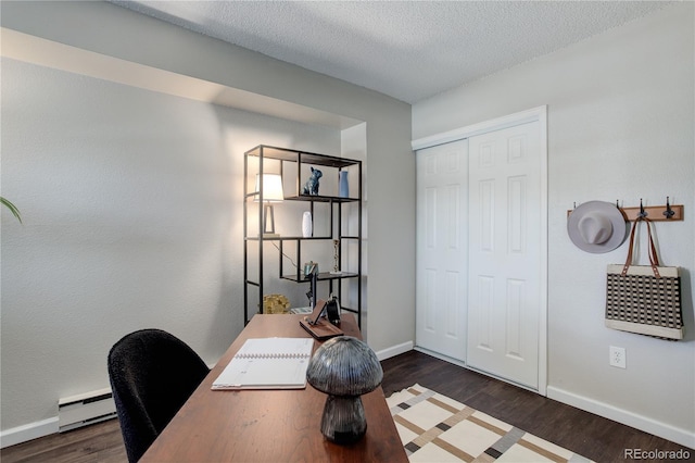 home office with a baseboard radiator, baseboards, a textured ceiling, and wood finished floors