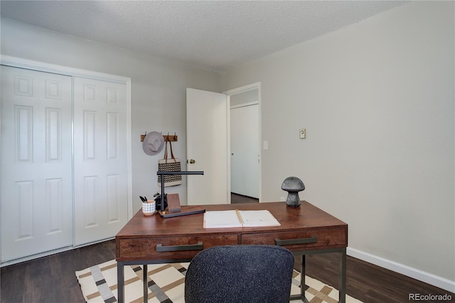 office with baseboards, a textured ceiling, and wood finished floors