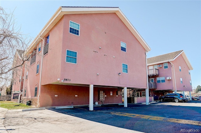 view of building exterior with uncovered parking