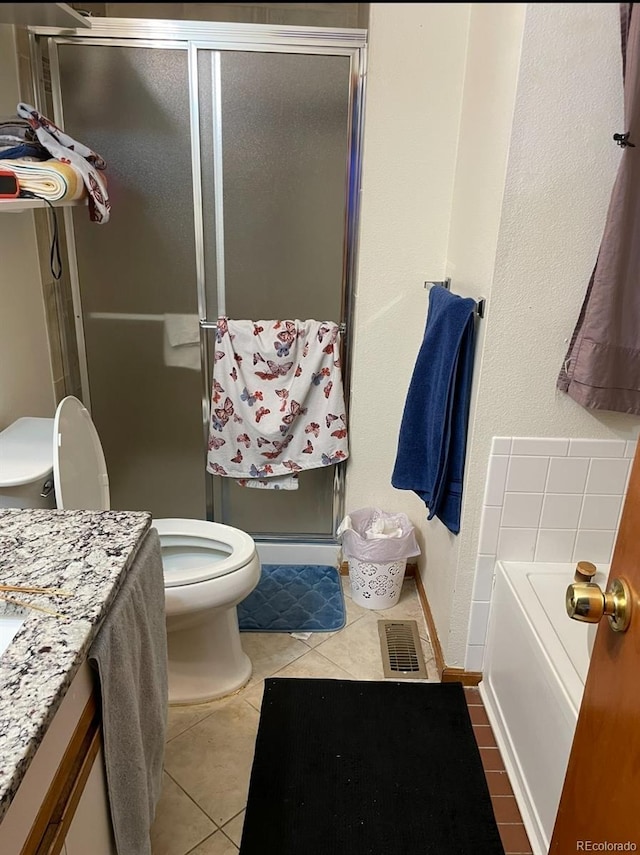 full bathroom featuring toilet, tile patterned floors, shower with separate bathtub, and vanity