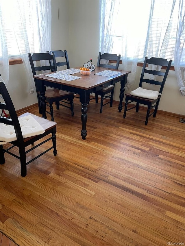 dining space with light hardwood / wood-style flooring