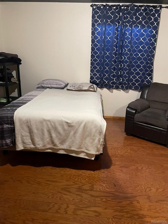 bedroom with wood-type flooring