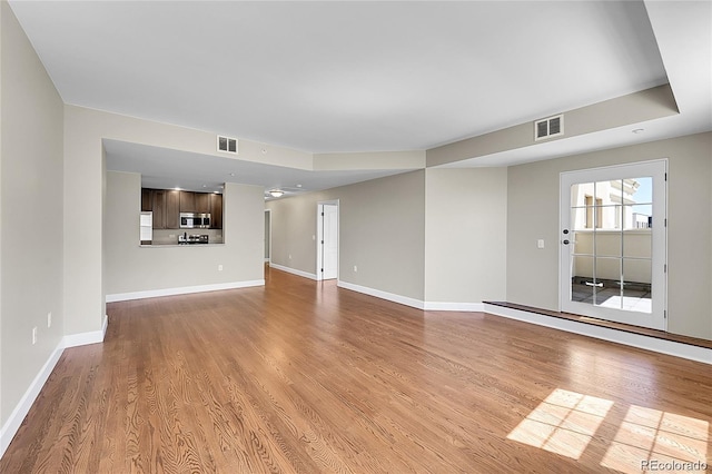 300 W 11th Ave Unit 8C, Denver, CO 80204 - unfurnished living room with light wood-type flooring and baseboards
