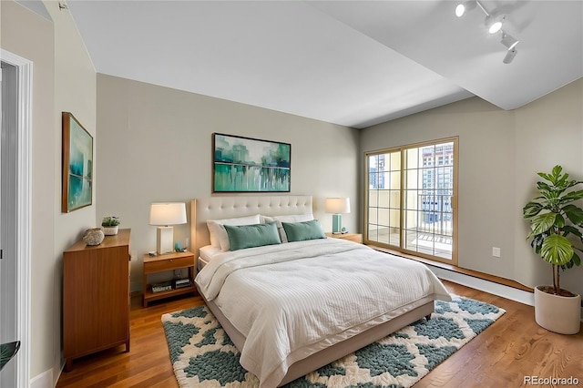 300 W 11th Ave Unit 8C, Denver, CO 80204 - bedroom featuring wood finished floors and rail lighting