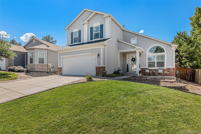 view of property featuring a front lawn and a garage