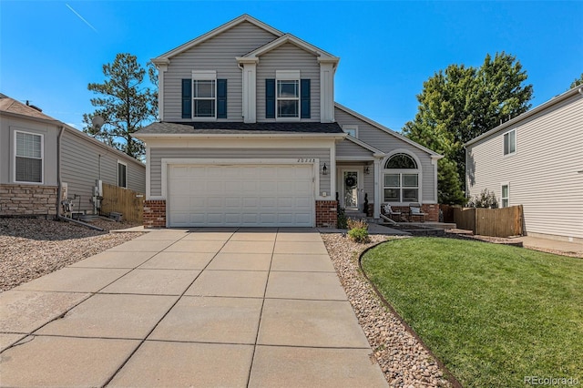 view of front of property featuring a front lawn and a garage