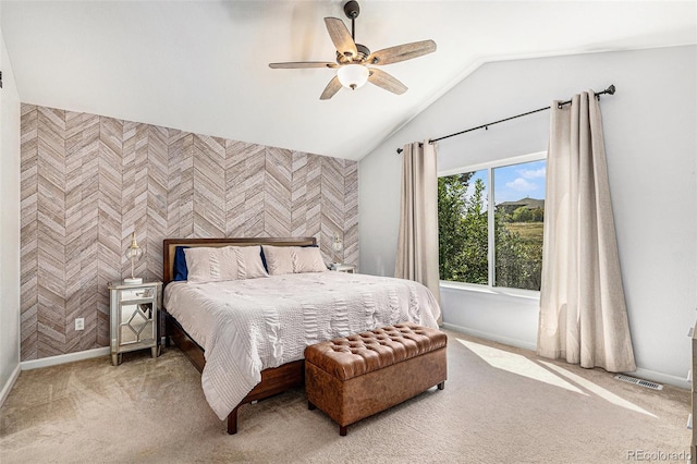 bedroom with vaulted ceiling, ceiling fan, and carpet flooring