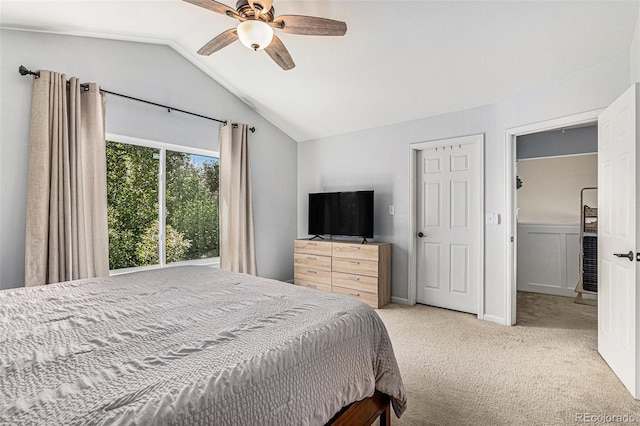 bedroom with lofted ceiling, ceiling fan, and light colored carpet