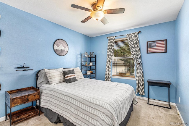 bedroom with light carpet and ceiling fan