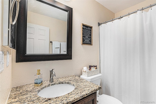 bathroom featuring toilet and vanity