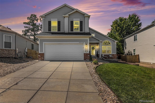 view of front of property featuring a lawn and a garage