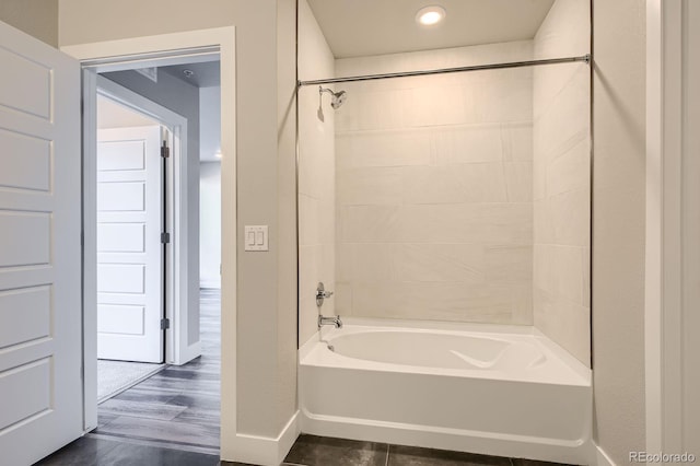 bathroom featuring baseboards,  shower combination, and recessed lighting