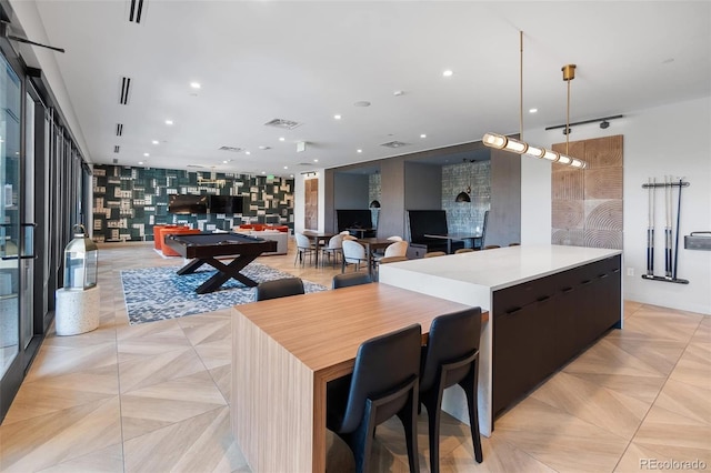 kitchen featuring a spacious island, recessed lighting, light countertops, open floor plan, and modern cabinets