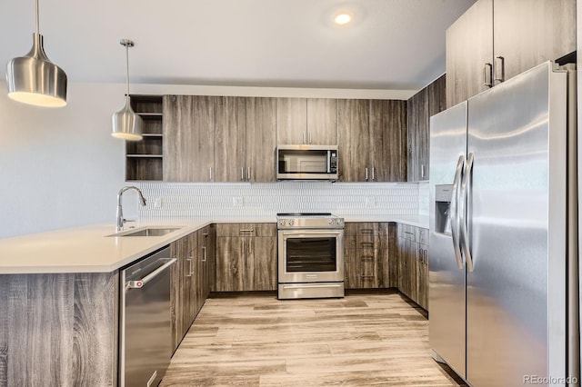 20 Wilcox St Unit 316, Castle Rock, CO 80104 - kitchen featuring stainless steel appliances, a sink, open shelves, and backsplash