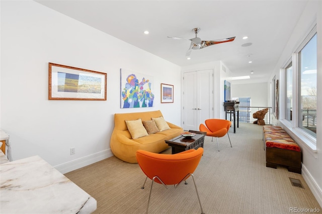 living room with light colored carpet and ceiling fan