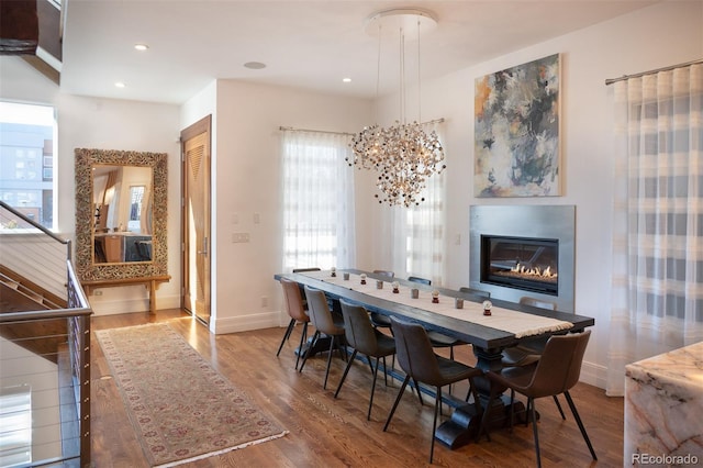 dining room with hardwood / wood-style flooring and a chandelier