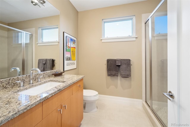 bathroom with vanity, toilet, tile patterned floors, and a shower with shower door