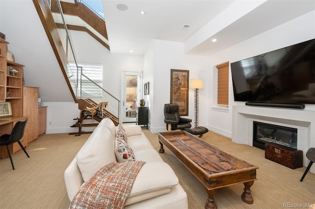 carpeted living room featuring vaulted ceiling