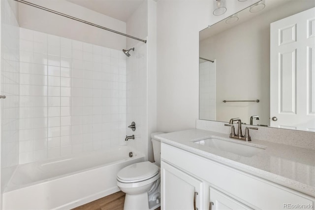 full bathroom with vanity, toilet, shower / bathing tub combination, and hardwood / wood-style flooring