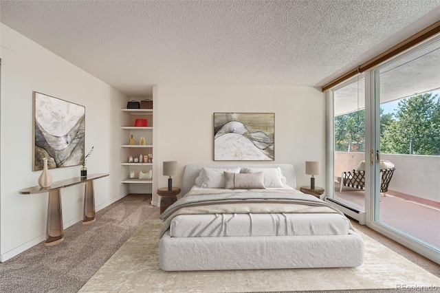 carpeted bedroom with access to exterior, a textured ceiling, and baseboard heating