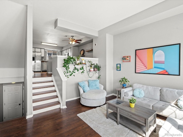 living room featuring stairway, a ceiling fan, baseboards, and wood finished floors