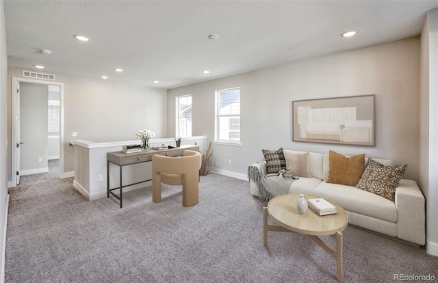 carpeted office with baseboards, visible vents, a textured ceiling, and recessed lighting