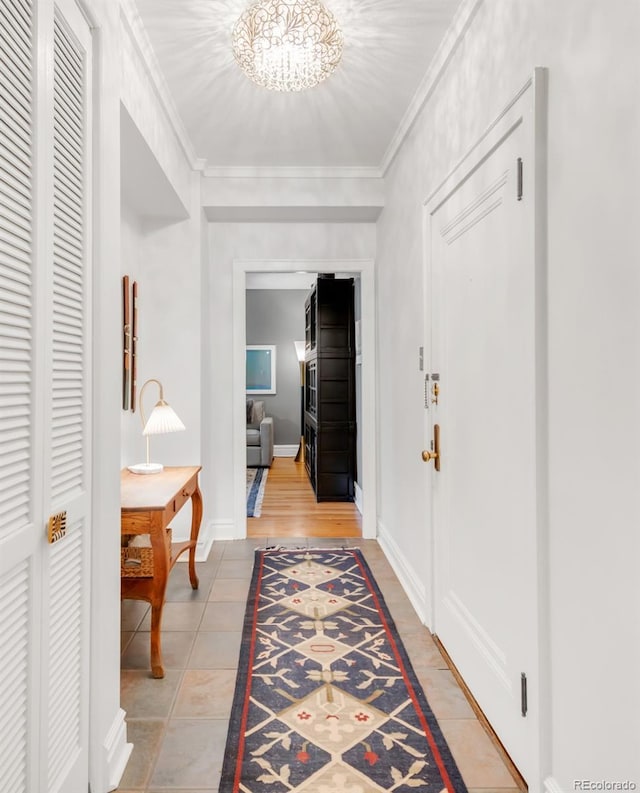99 S Downing St Unit 105, Denver, CO 80209 - hall featuring crown molding, a chandelier, and light tile patterned floors