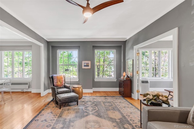 99 S Downing St Unit 105, Denver, CO 80209 - living area with ceiling fan, wood finished floors, and an AC wall unit