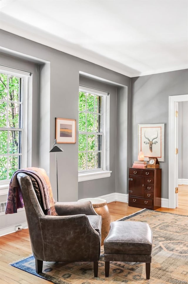 99 S Downing St Unit 105, Denver, CO 80209 - sitting room featuring plenty of natural light and wood finished floors