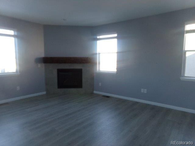 unfurnished living room featuring dark hardwood / wood-style flooring