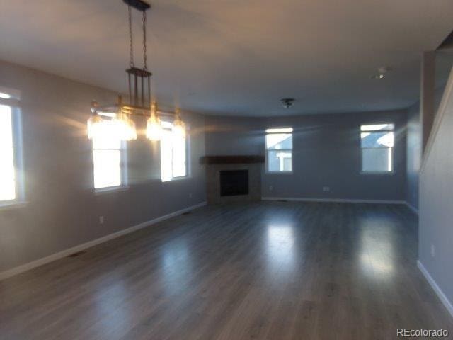 unfurnished living room with dark hardwood / wood-style floors