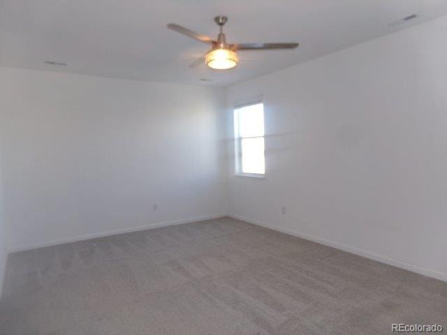 spare room with carpet floors and ceiling fan