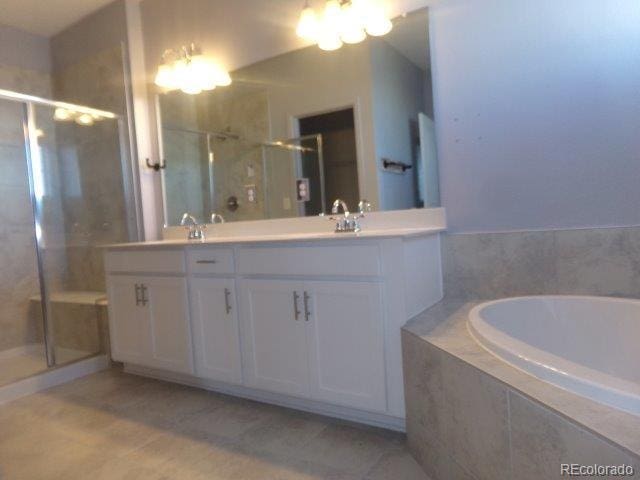 bathroom with vanity and independent shower and bath