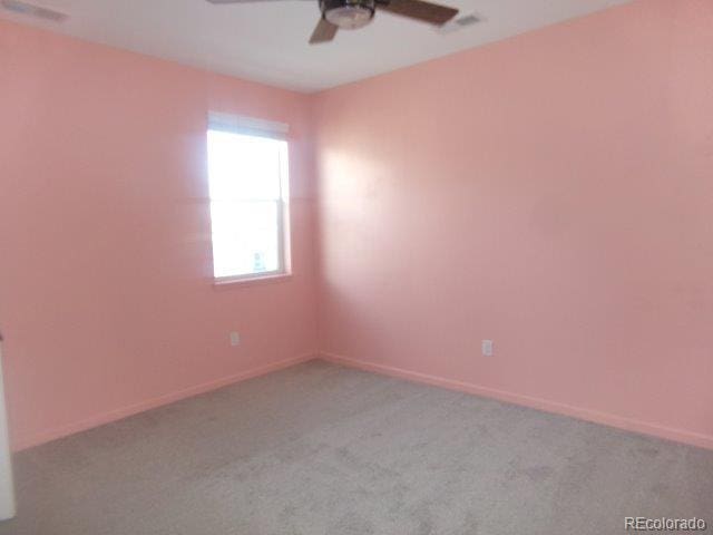 empty room with light colored carpet and ceiling fan