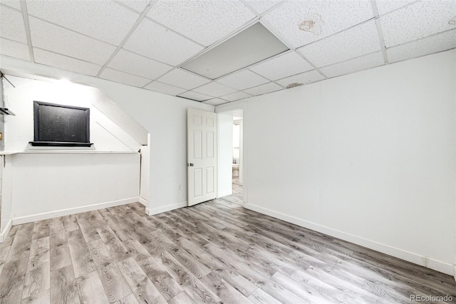 bonus room with baseboards and wood finished floors