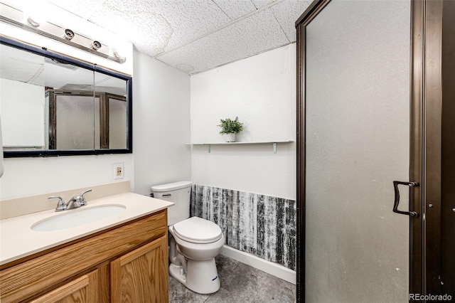 full bath featuring vanity, toilet, and a shower with door