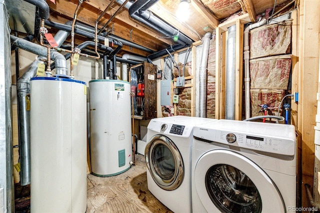 laundry area with laundry area, gas water heater, and washing machine and dryer