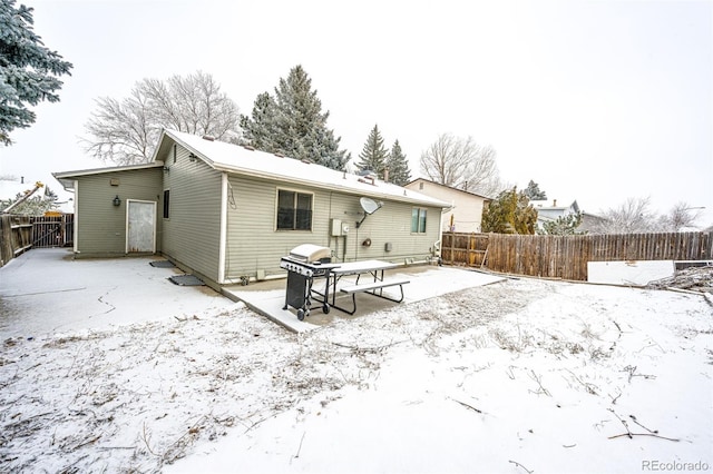 back of property featuring fence and a patio