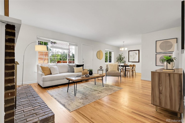 797 W Briarwood Ave, Littleton, CO 80120 - living room featuring a chandelier, light wood-style floors, and baseboards