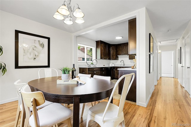 797 W Briarwood Ave, Littleton, CO 80120 - dining area with light wood-style floors, a chandelier, and baseboards