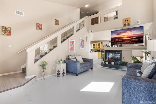20414 E 55th Pl, Denver, CO 80249 - living area with stairway, a towering ceiling, recessed lighting, and baseboards