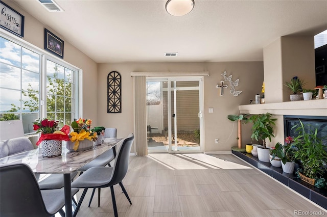 20414 E 55th Pl, Denver, CO 80249 - dining space with healthy amount of natural light, baseboards, and a tile fireplace